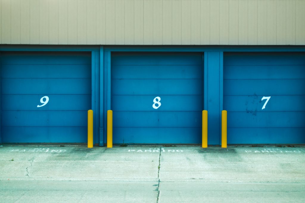 numbers on garage doors with yellow bollards showing 11:11