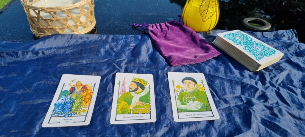 Tarot cards - Mastery, King of Pentacles and Page of Pentacles.
